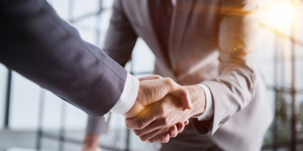 Handshake of two businessmen who enters into the contract to develop a new software