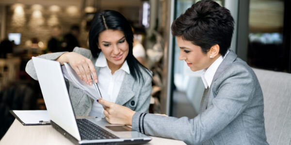 Two businesswomen nice discussing on meeting